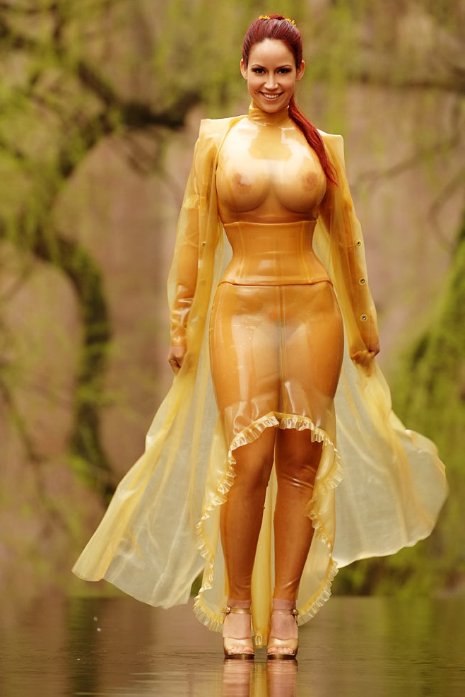 Redhead Girl wearing Yellow Latex See Through Long Dress and Golden High Heels